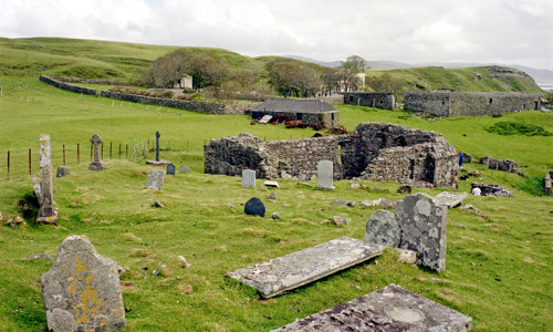 The remains of Inchkenneth Chapel surrounded by old gravestones.